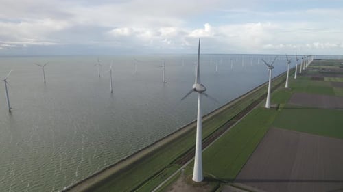 Aerial shots reveal rows of offshore wind turbines standing tall above the sea, harnessing wind ener
