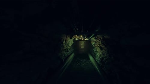 Bright Headlight Highlights Wet Reflections in Confined Underground Corridor