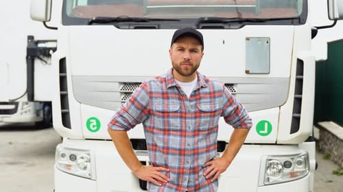 Confident Man Standing in Front of Semi-Truck