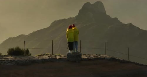 Flying Around Pair of Hikers on the Top of Mountain Aerial Drone Shot of Man and Woman Travel with