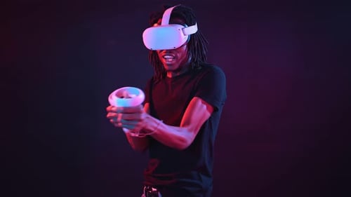 Man Enjoys Virtual Reality Experience in Dark Room