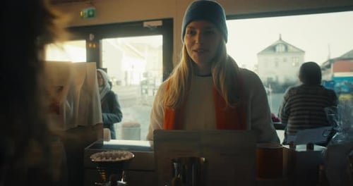 Customer and Barista Interact in Cafe