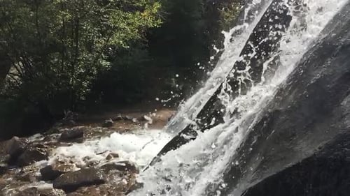 The side view of a waterfall in slow motion.