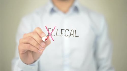 Crossing Out the Word Illegal with a Marker