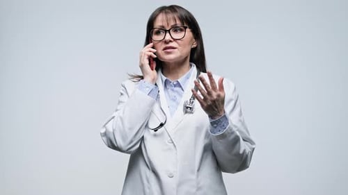 Doctor Talking on Cellphone in Hospital Setting