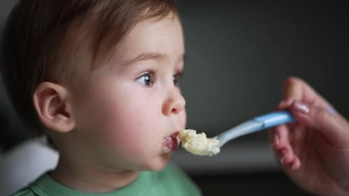 Baby Being Fed Food with Spoon Close Up