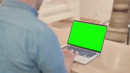 Mature Man Using Laptop with Chroma Key Screen