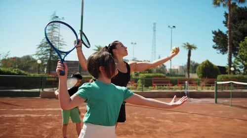 Tennis Lesson with Young Girl and Boy on Court