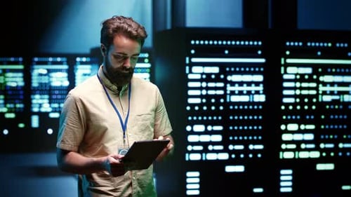 Man with Tablet in Server Room