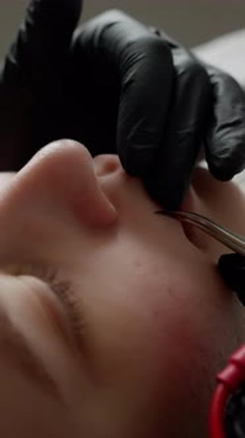 Woman Receiving Facial Treatment by Health Professional