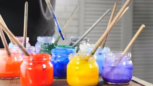 Painting Tools Brushes in Glass Jars Waiting for Work