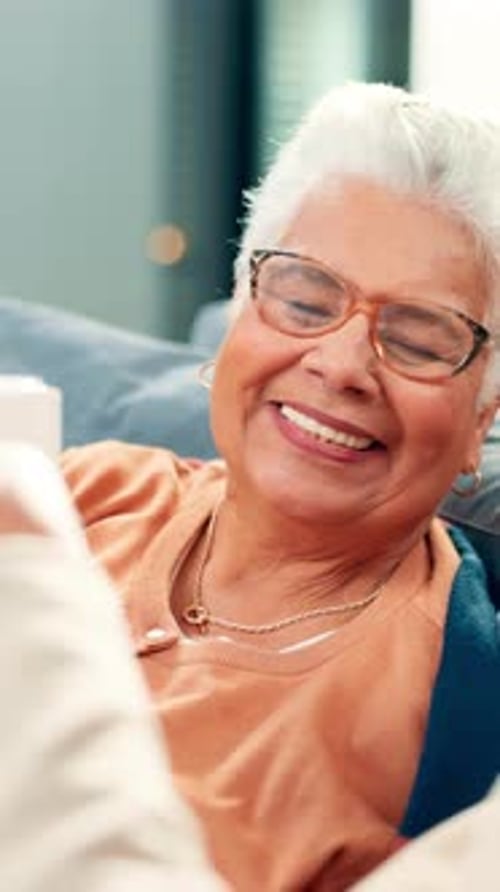 Senior Woman Smiling and Drinking from Mug Indoors