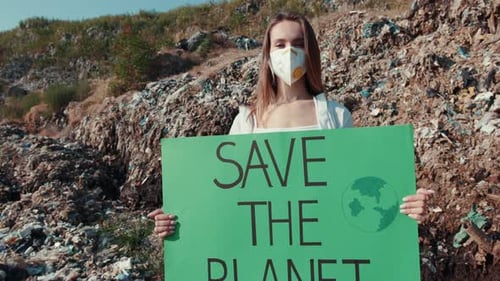 Young Adult Woman Protesting in Front of Landfill
