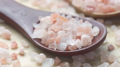Closeup view of wooden spoons with Himalayan salt crystals