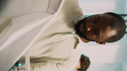 Adult Examining a Light Blue Button-Up Shirt