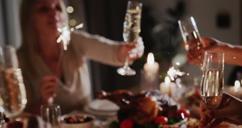 Friends Celebrate With Champagne and Sparklers at Dinner