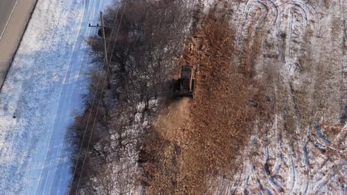 Drone View of Heavy Machinery Clearing Land Near Roadside A Bulldozer Removes Trees and Brush
