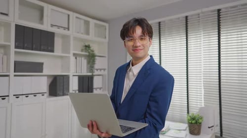 Portrait of Asian young businessman working in the office workplace.