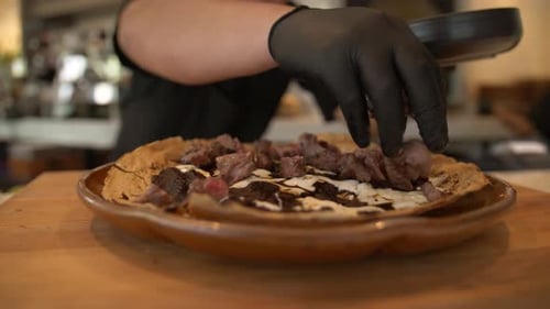 Chef Preparing a Delicious Meat Dish in Restaurant
