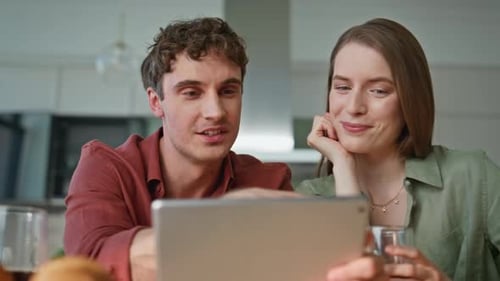 Young Couple Using Tablet in Modern Kitchen