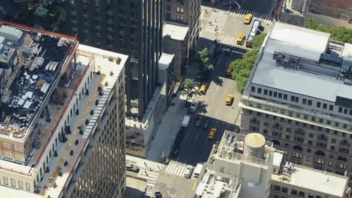 Top view of an urban area of Manhattan on a sunny day with a lot of yellow taxis in the streets, sta