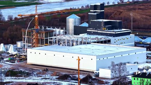 Factory construction site aerial parallax Latvia winter morning
