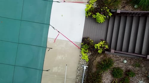 Drone showing a winterized pool in suburbia.