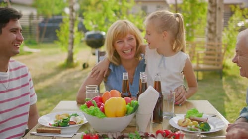 Big Family Garden Party Celebration, Gathered Together at the Table, Eating, Joking and Having Fun.
