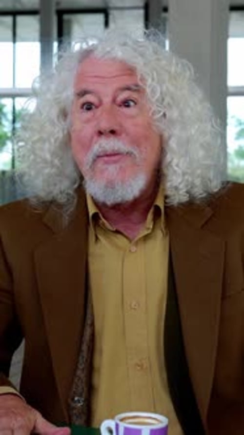 Happy Senior Man Enjoying Breakfast with Friends at Coffee Bar