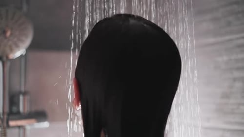 Water Falls on Head Flowing Along Hair of Lady