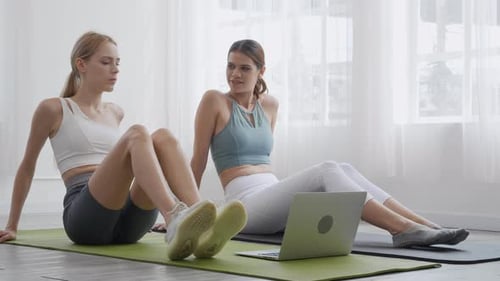 Women Exercising Together in Bright, Airy Home
