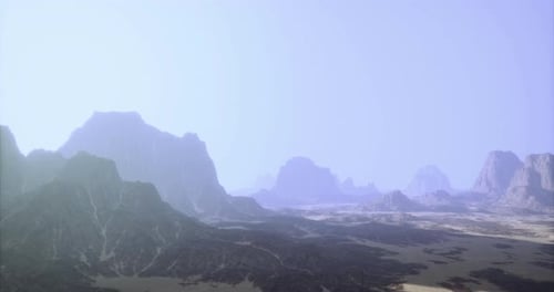 Mountains and Valleys Under a Hazy Sky in a Serene Desert Landscape
