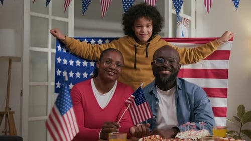 Family Celebrates With American Flags at Home