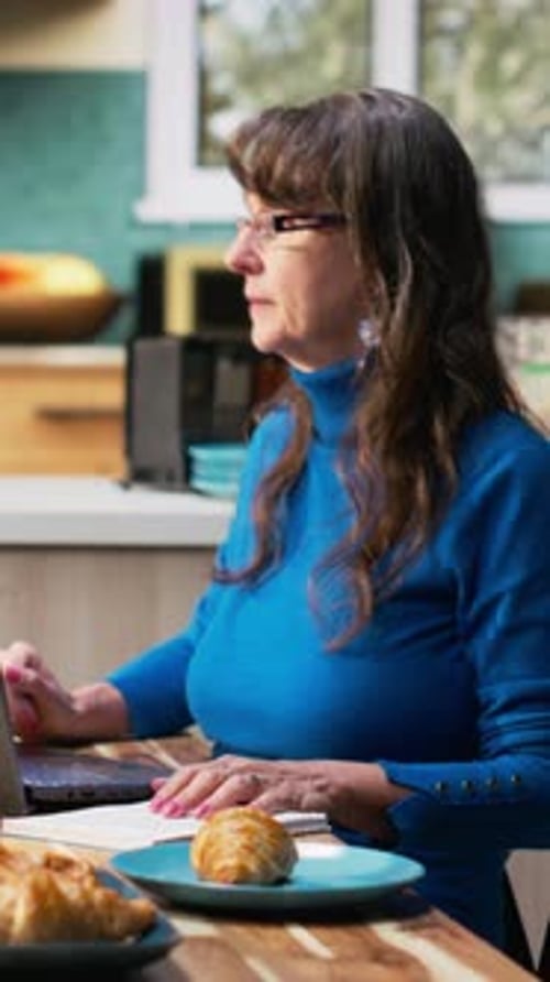 Vertical Video Senior Married Couple Writing a Grocery List Together on Textbook