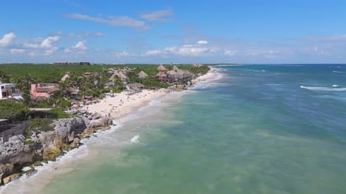 Gentle waves rolling into the white sand beach at Tulum, Quintana Roo