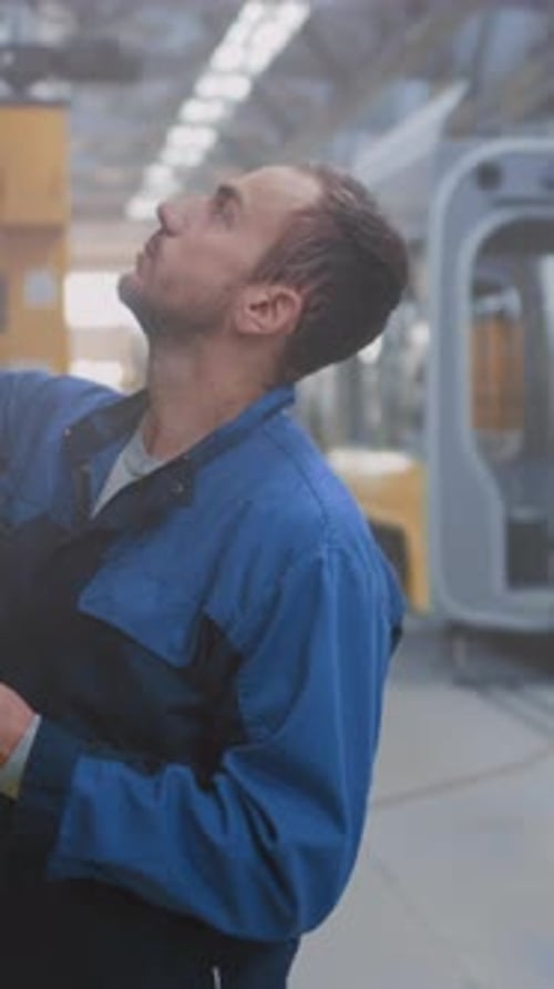 White Male Engineer Carefully Examining Machine Errors and Performing Troubleshooting Tasks on
