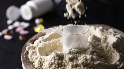 Spoon Pouring with Dry Sport Protein Whey Powder
