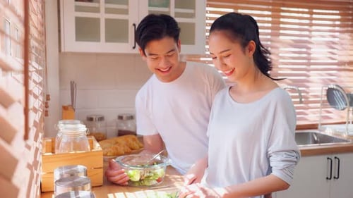 Couple Cooking Together in Bright Sunny Kitchen