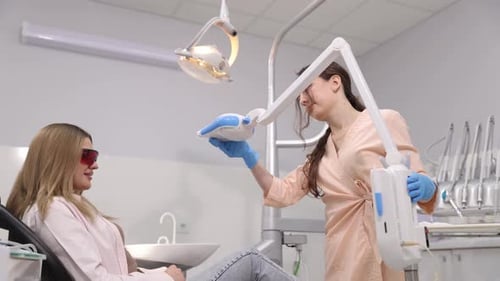 An Advanced Dental Procedure is Occurring with a Patient in a Modern Equipped Clinic