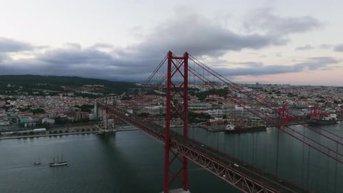 Aerial view in front of the 25th of April bridge on Tajo river, sunset in Lisbon
