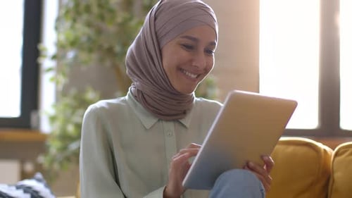 Happy Woman Using Tablet in Apartment