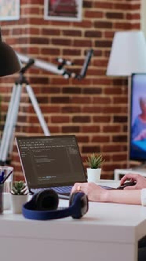 Vertical Video Software Developer Types Programming Code in a Cozy Home Office Setup