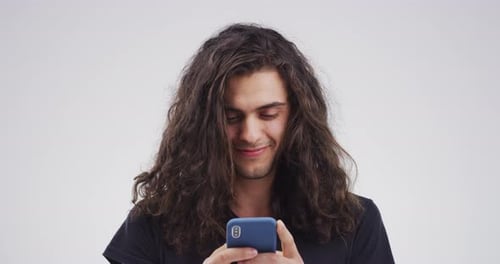 Young Adult With Long Hair Using Smartphone