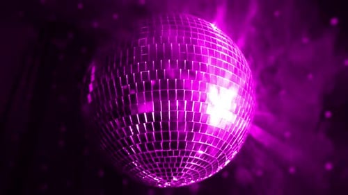 Disco ball spins and reflects colorful lights at a vibrant party atmosphere