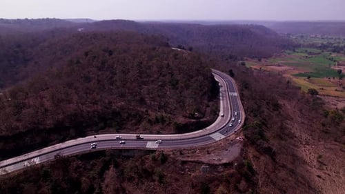 big Hill mountains with Ghat road and moving vehicles, day time, semi orbit, drone shot, 4k.