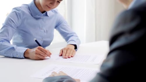 Successful business deal in the office with contract signing and handshake