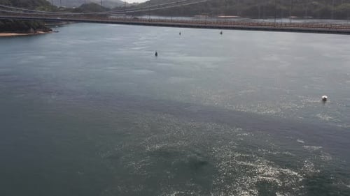 Aerial shot revealing bridge over Japan inland sea in Summer