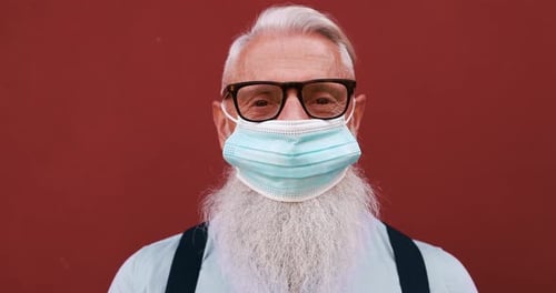 Senior man wearing glasses and a mask