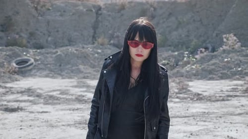 Stylish Woman Walks Through Desert Landscape