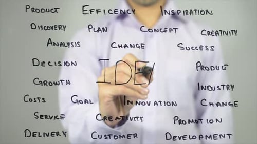 Man Writes Idea on Glass Surface